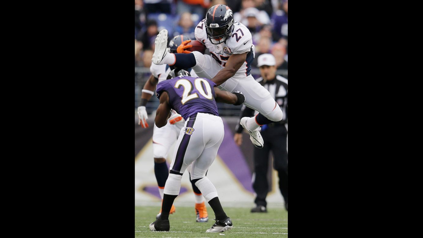 Running back Knowshon Moreno of the Broncos jumps over free safety Ed Reed of the Ravens while rushing the ball during the first half on Sunday.