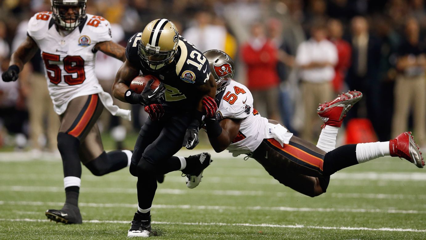 Marques Colston of the Saints slips a tackle by Lavonte David of the Buccaneers on Sunday.