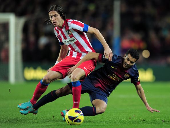 Barcelona's forward Pedro Rodriguez and Atletico's Filipe Luis go in for a challenge as La Liga's top two went head-to-head. Barca had taken an incredible 43 points from a possible 45, winning 14 of their 15 league games to lead Atletico by six points.