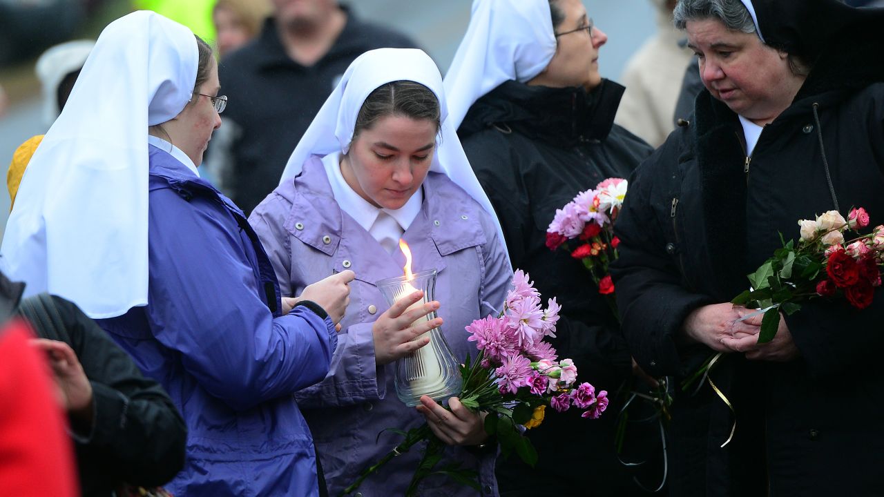 Nuns pay their respects at a makeshift shrine to the victims on December 16.