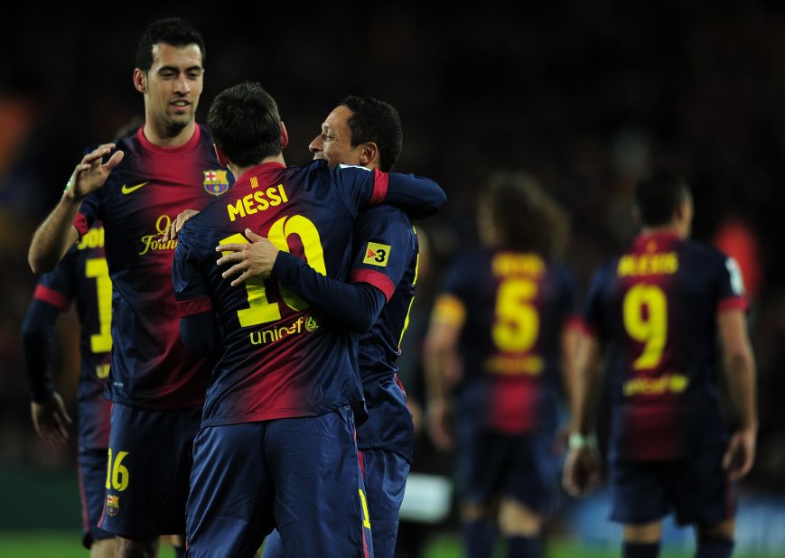 Messi celebrates with fellow goalscorers Busquets and Adriano as Barca move into a 3-1 lead at Camp Nou.