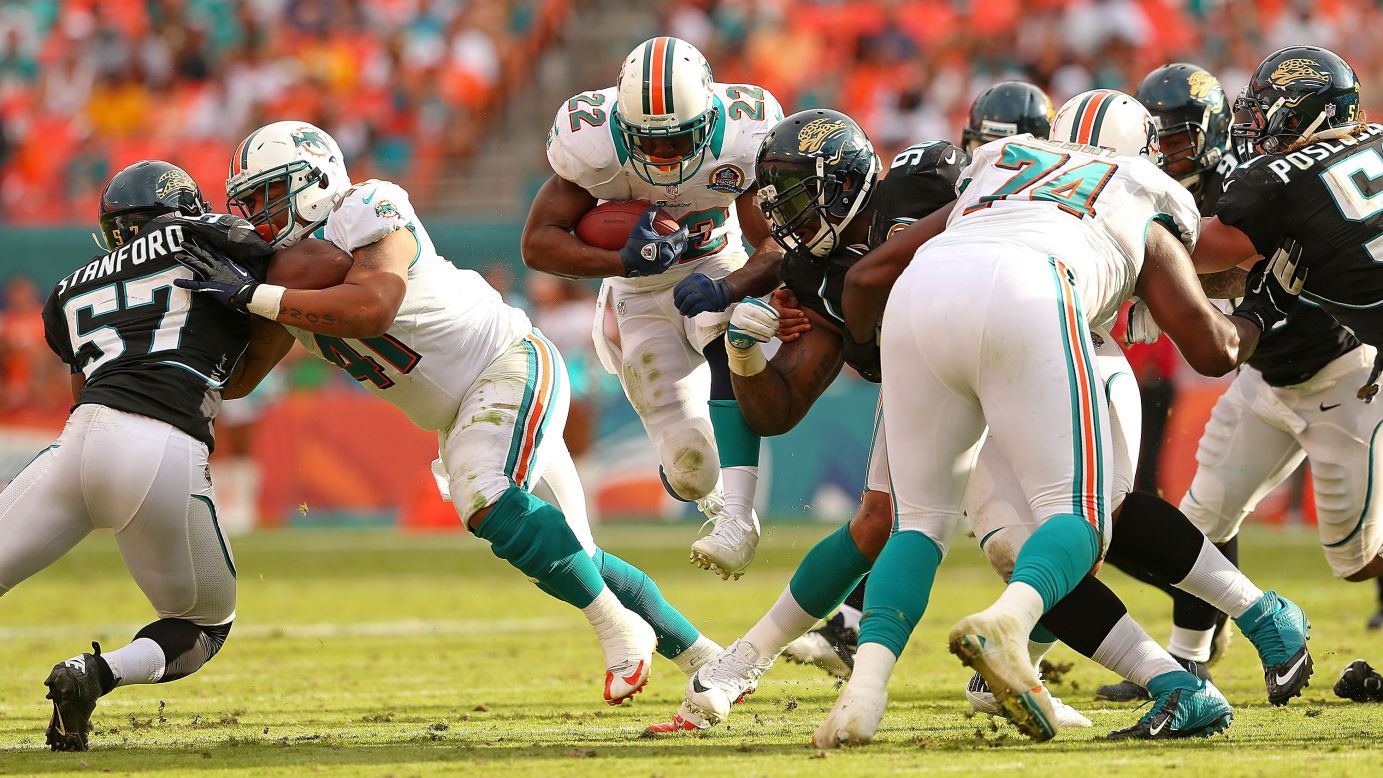 Reggie Bush of the Dolphins rushes during a game against the Jaguars on Sunday.