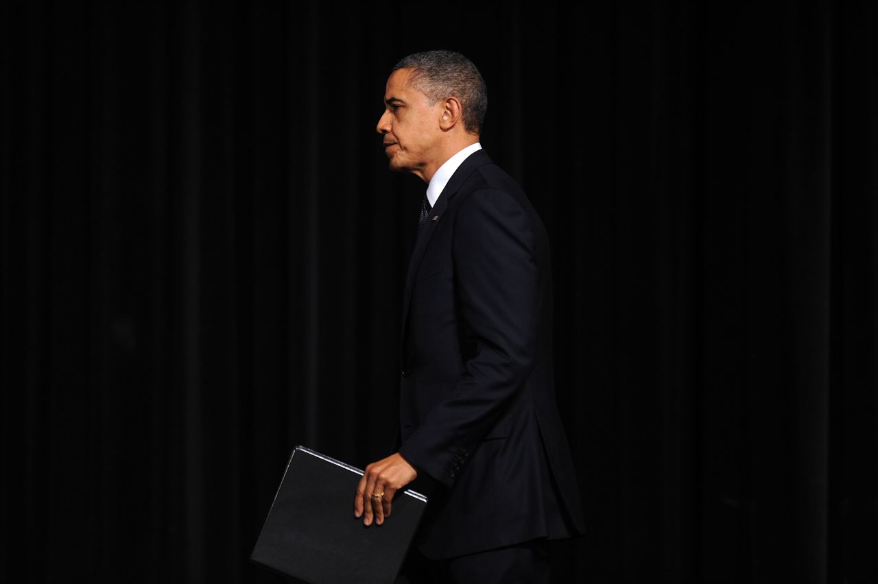 President Obama takes the Newtown High School auditorium stage for his address at the interfaith prayer vigil. 
