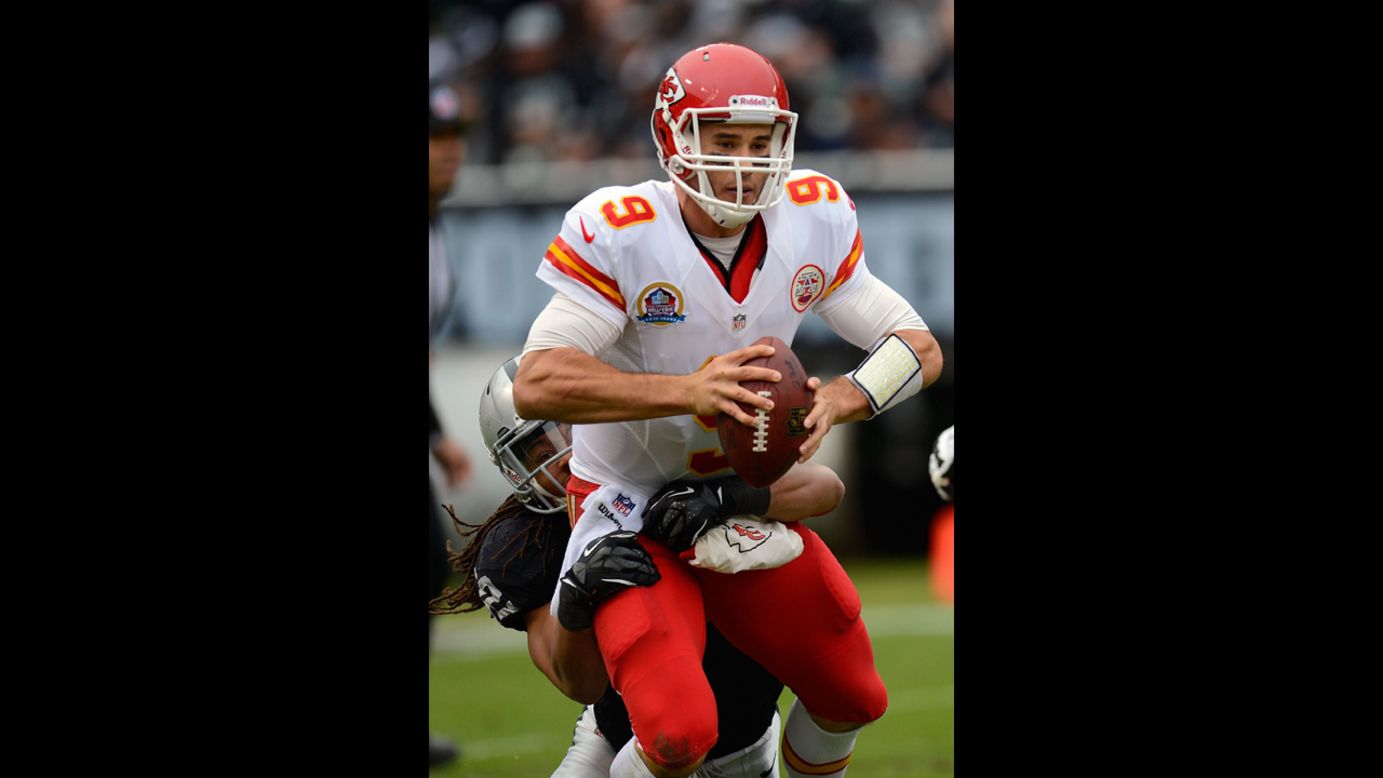 Brady Quinn of the Chiefs gets sacked by Philip Wheeler of the Raiders in the first quarter on Sunday.