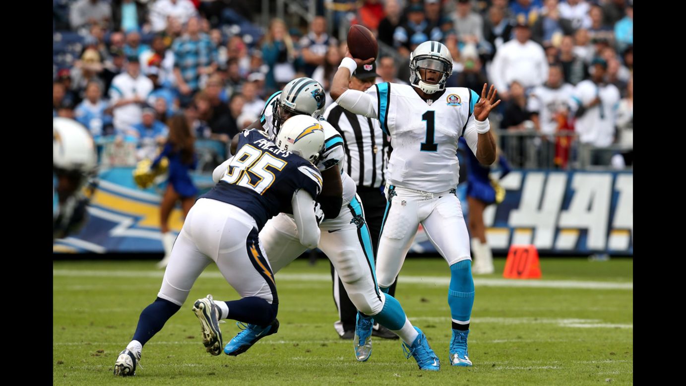 Quarterback Cam Newton of the Panthers throws a pass over linebacker Shaun Phillips of the Chargers on Sunday.