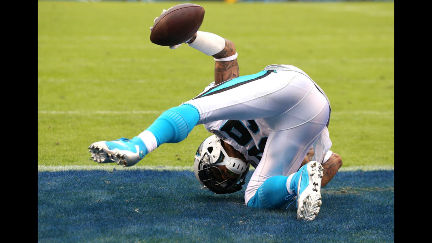 Wide receiver Steve Smith of the Panthers holds up the ball as he rolls after making a diving catch in the end zone on a 4-yard touchdown play in the third quarter against the Chargers on Sunday.