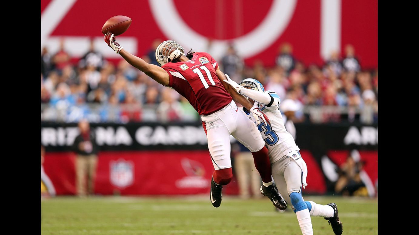 Wide receiver Larry Fitzgerald of the Cardinals is unable to make a leaping reception under pressure from cornerback Chris Houston of the Lions on Sunday.