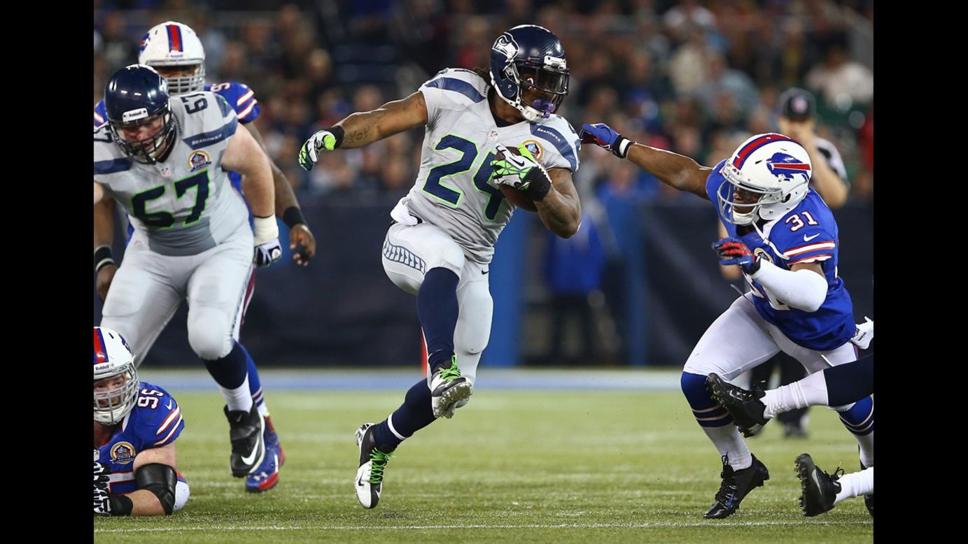 Marshawn Lynch of the Seahawks carries the ball as Jairus Byrd of the Bills attempts to tackle him on Sunday.