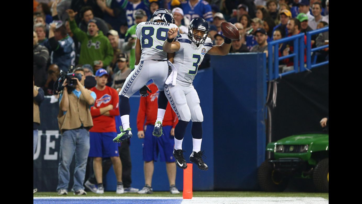 Russell Wilson of the Seahawks celebrates his rushing touchdown with teammate Doug Baldwin during the game against the Bills on Sunday.