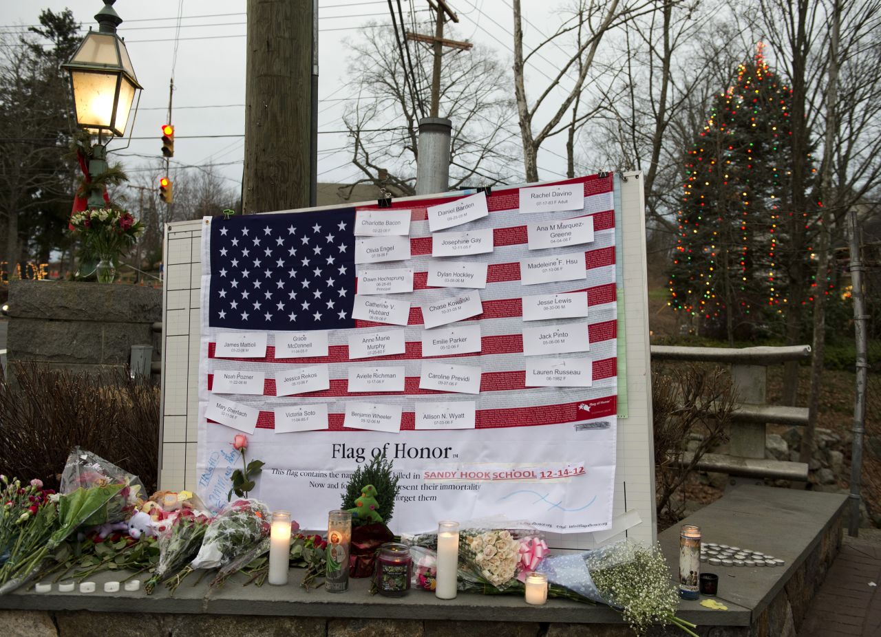 Names of victims are displayed on a flag in the business area of Newtown, Connecticut, on December 16.