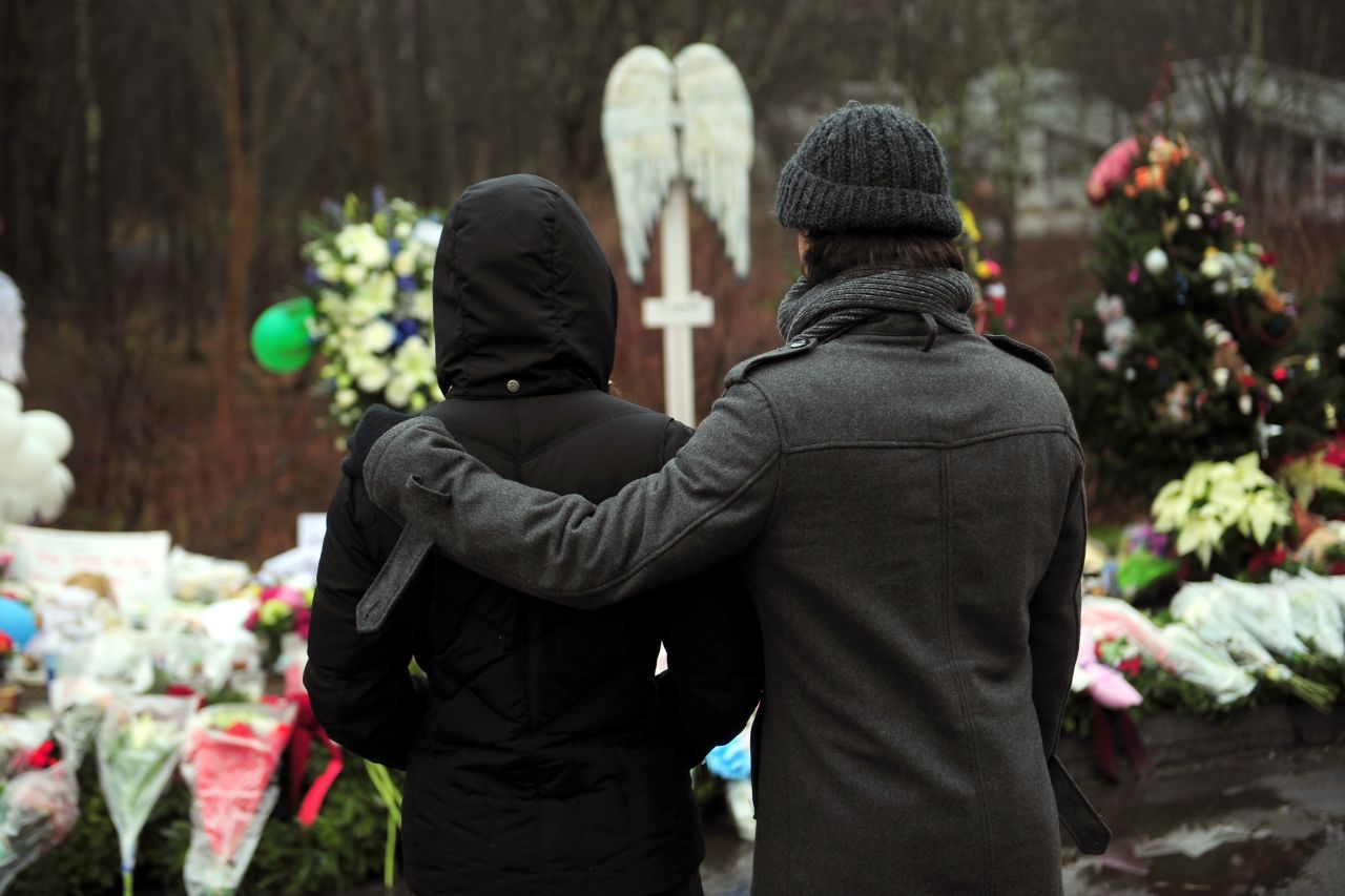 People pay their respects on Monday, December 17, at a memorial to the victims of an elementary school shooting in Newtown, Connecticut.