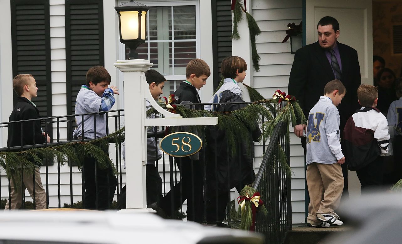 Boys enter Honan Funeral Home before Jack Pinto's funeral on December 17 in Newtown.