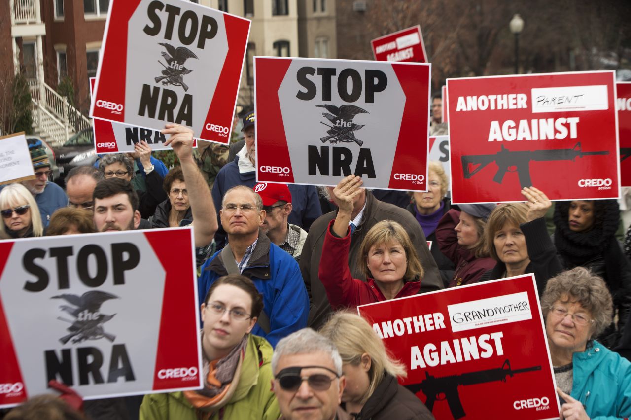 Protesters march on the National Rifle Association's Capitol Hill lobbyist offices in Washington on December 17.