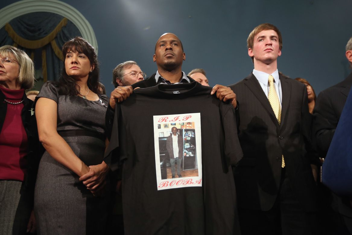 Chris Foye, whose son Chris Owens was killed by a stray bullet in 2009, stands with other survivors and family members of gun violence at Bloomberg's press conference on December 17 in New York.