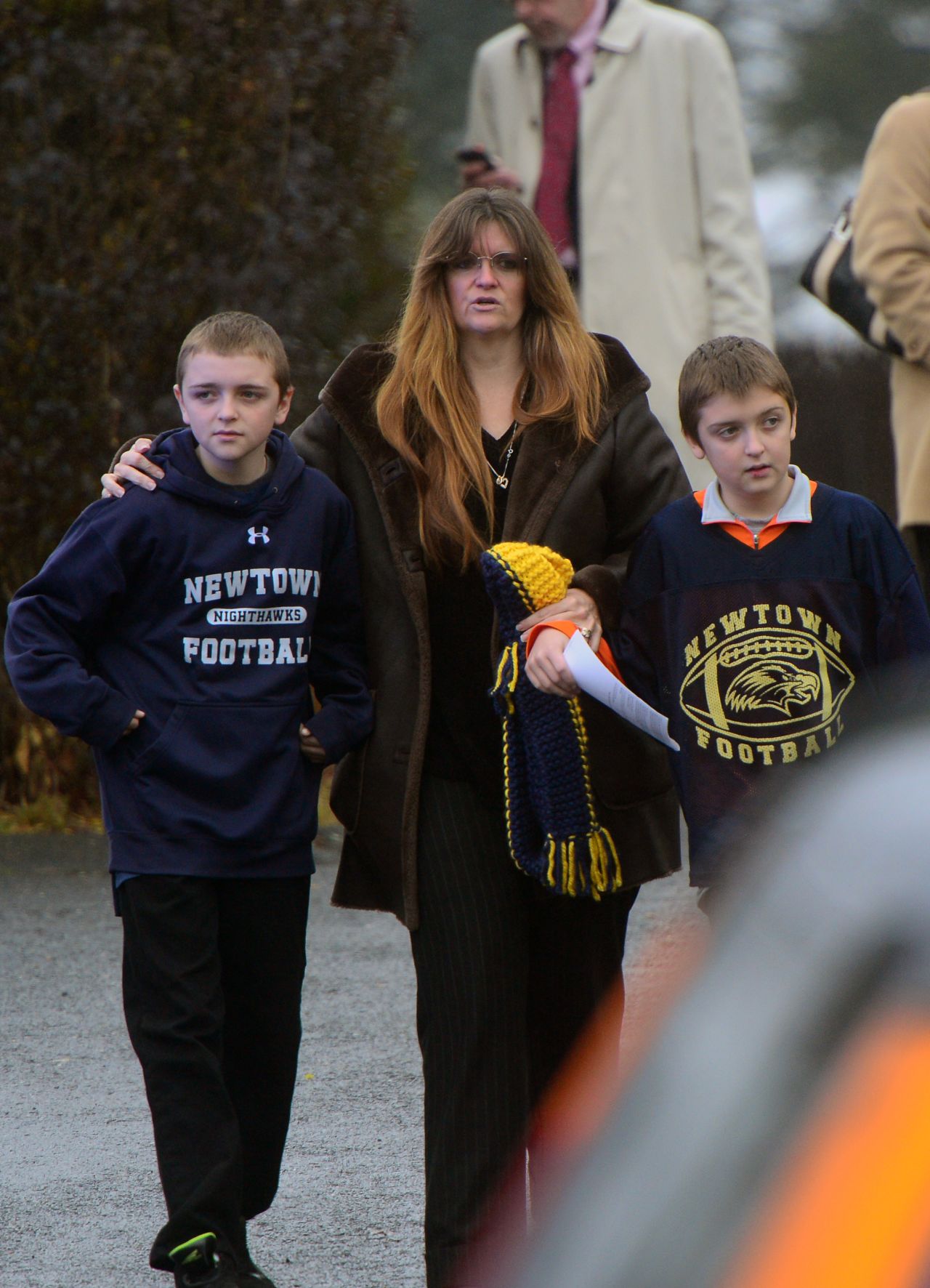 A mother and two children attend  the funeral for Jack Pinto on December 17. Children are among those crowding the funeral for the 6-year-old boy.