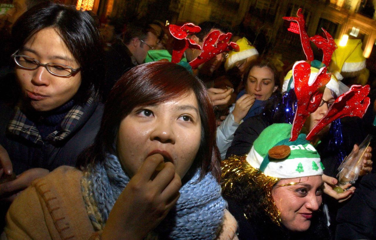 A crowd of people gathered in Puerta del Sol in Madrid stuff their faces with 12 grapes to celebrate the New Year, each representing a month in the year ahead. Similar grape-related larks are practiced in Mexico, Chile and Costa Rica