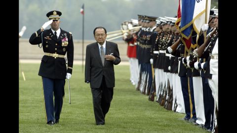 Inouye, center, is escorted by Army Gen. Charles Taylor while inspecting troops outside the Pentagon during the annual National POW/MIA Recognition Day ceremony September 14, 2004. Inouye lost an arm in World War II combat. 