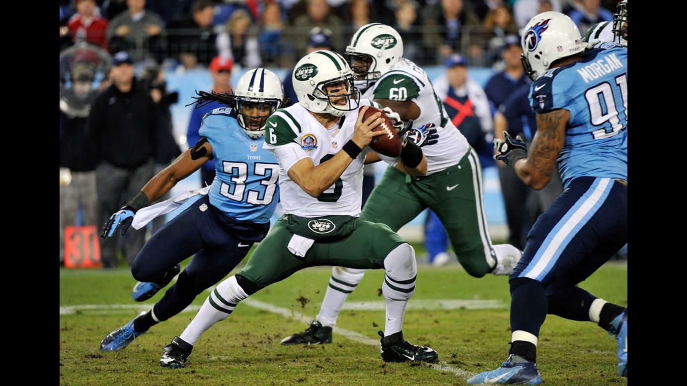 Jets quarterback Sanchez is pressured by Titans safety Michael Griffin on Monday.