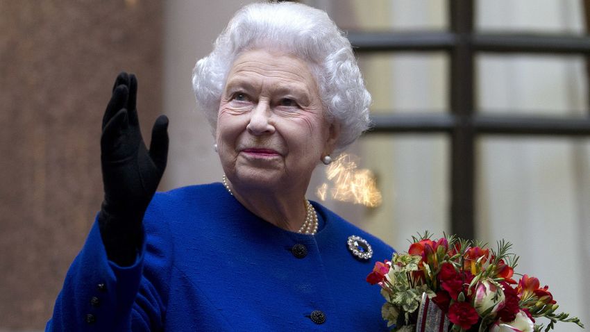 Queen Elizabeth II looks up and waves to members of staff of The Foreign and Commonwealth Office as she ends an official visit which is part of her Jubilee celebrations on December 18, 2012 in London.