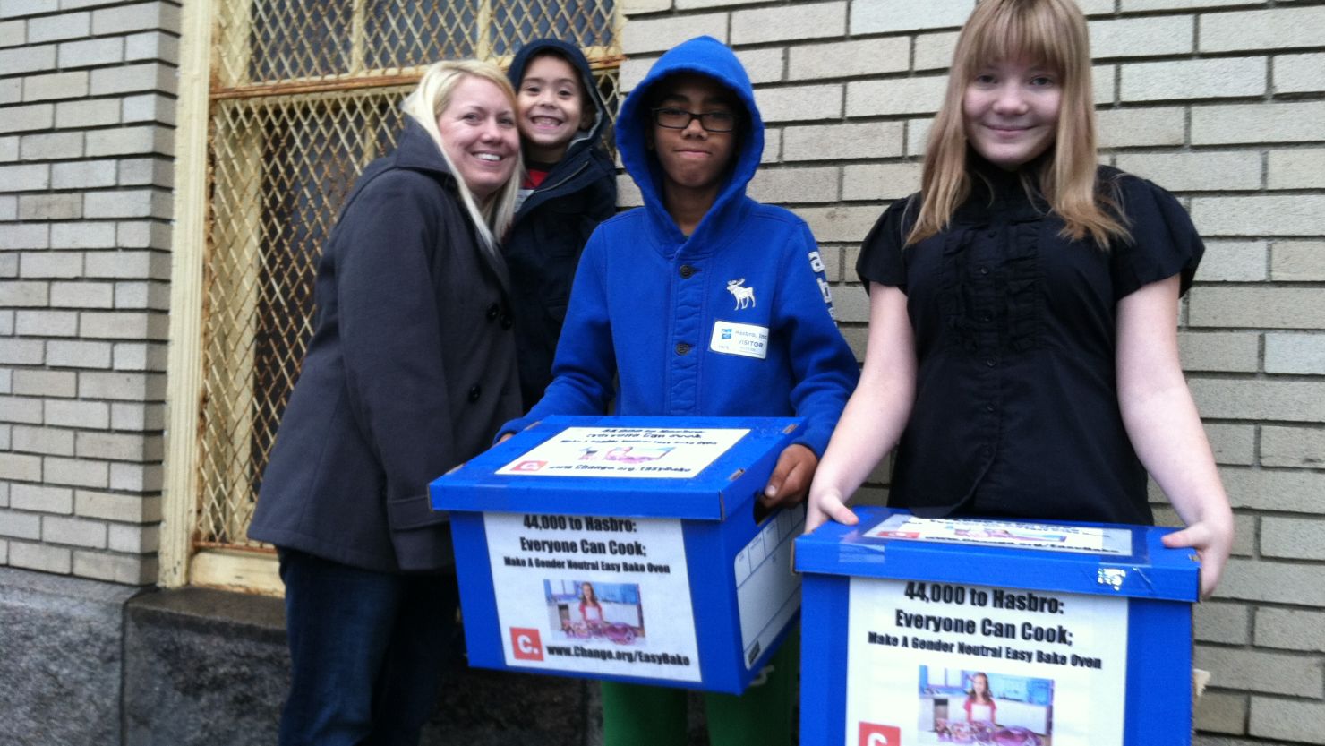 McKenna Pope (right) delivers petition signatures to Hasbro's headquarters in Pawtucket, Rhode Island, with mother Erica Boscio and brothers Gavyn and Matthew Boscio (left to right).