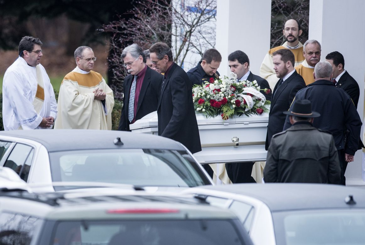 Pallbearers carry out James Mattioli's casket at St. Rose of Lima Roman Catholic Church after a funeral Mass on December 18 in Newtown. James, 6, was one of the 26 victims in the shooting at Sandy Hook Elementary School in Newtown. 