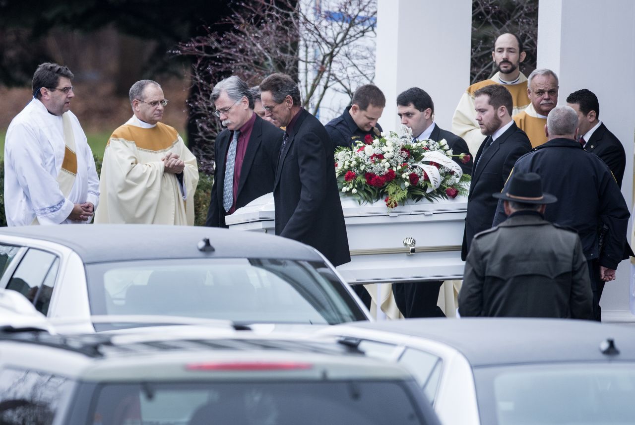 Pallbearers carry out James Mattioli's casket at St. Rose of Lima Roman Catholic Church after a funeral Mass on December 18 in Newtown. James, 6, was one of the 26 victims in the shooting at Sandy Hook Elementary School in Newtown.