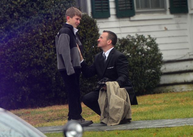 A man comforts a young boy after the funeral for Jack Pinto, 6, one of the children killed when Adam Lanza stormed their elementary school and claimed the lives of 20 children and six adults after killing his mother. Lanza turned the gun on himself as police closed in. 