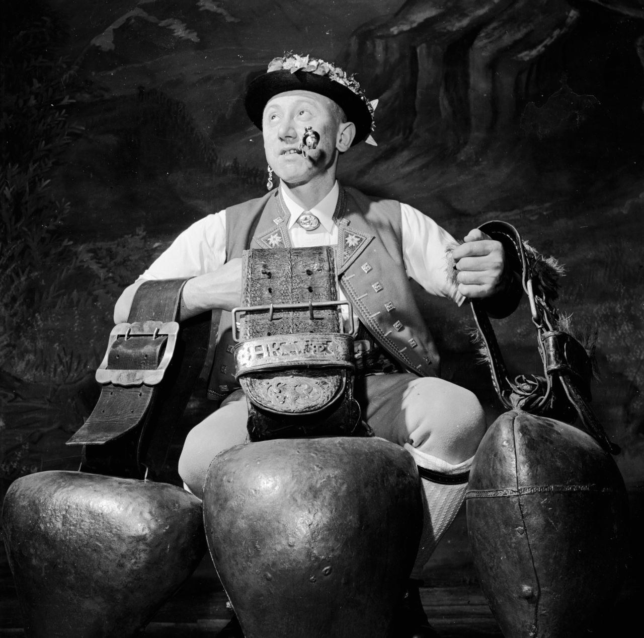 An Alpiner with three large cow bells, which produce that sombre rhythmic sound, at a traditional bell-swinging festival in 1955.