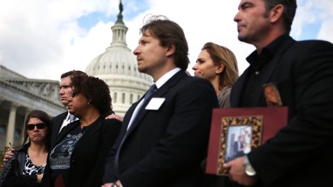 Survivors and family members of victims of gun violence listen during a news conference on Capitol Hill December 18.