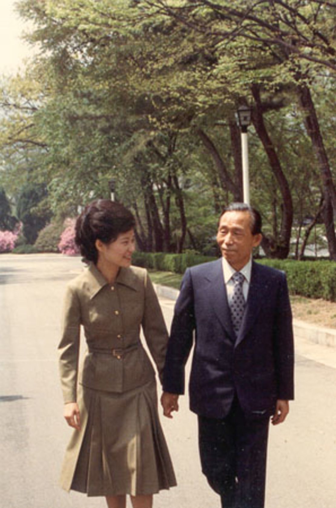 Park Geun-hye walks with her late father and former president Park Chung-hee in 1977.