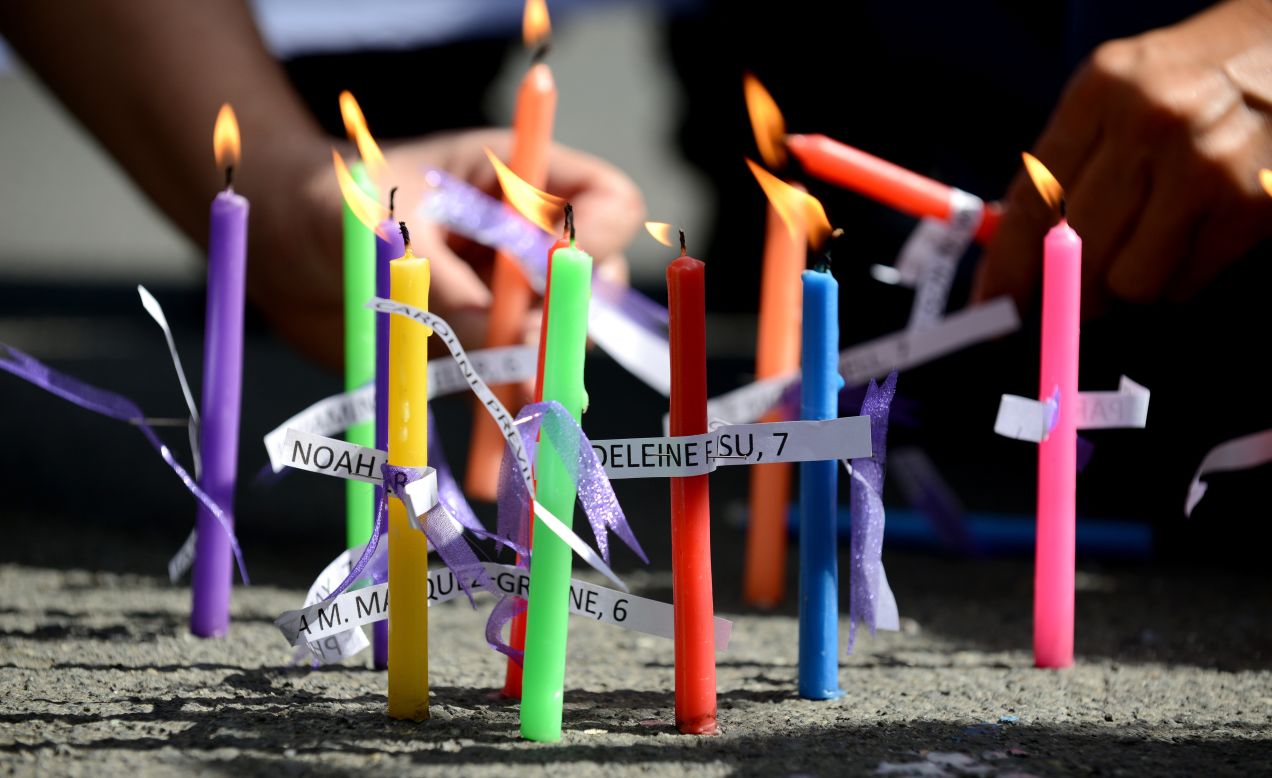 Members of the human rights group Volunteers Against Crime and Corruption light candles showing the names of those killed during the shooting at Sandy Hook Elementary School, during a prayer vigil in front of the U.S. Embassy in Manila, Philippines on December 18.