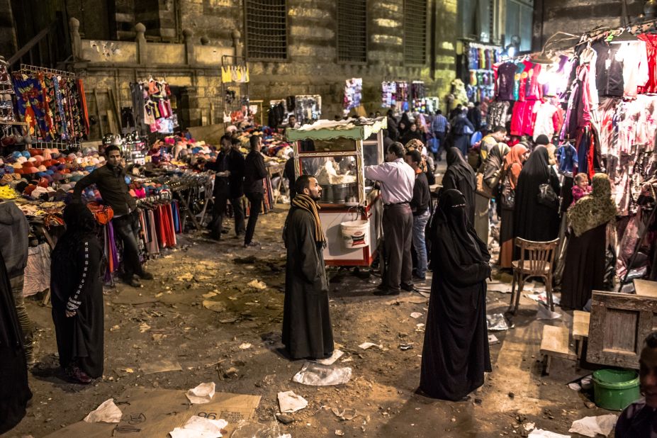 People make their way through a market place on Monday, December 17, in Cairo. 