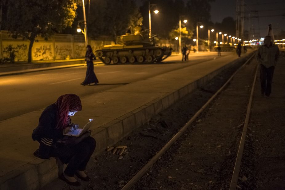 An Egyptian woman types on her laptop before the start of a demonstration opposing President Mohamed Morsy on December 18 in Cairo. 