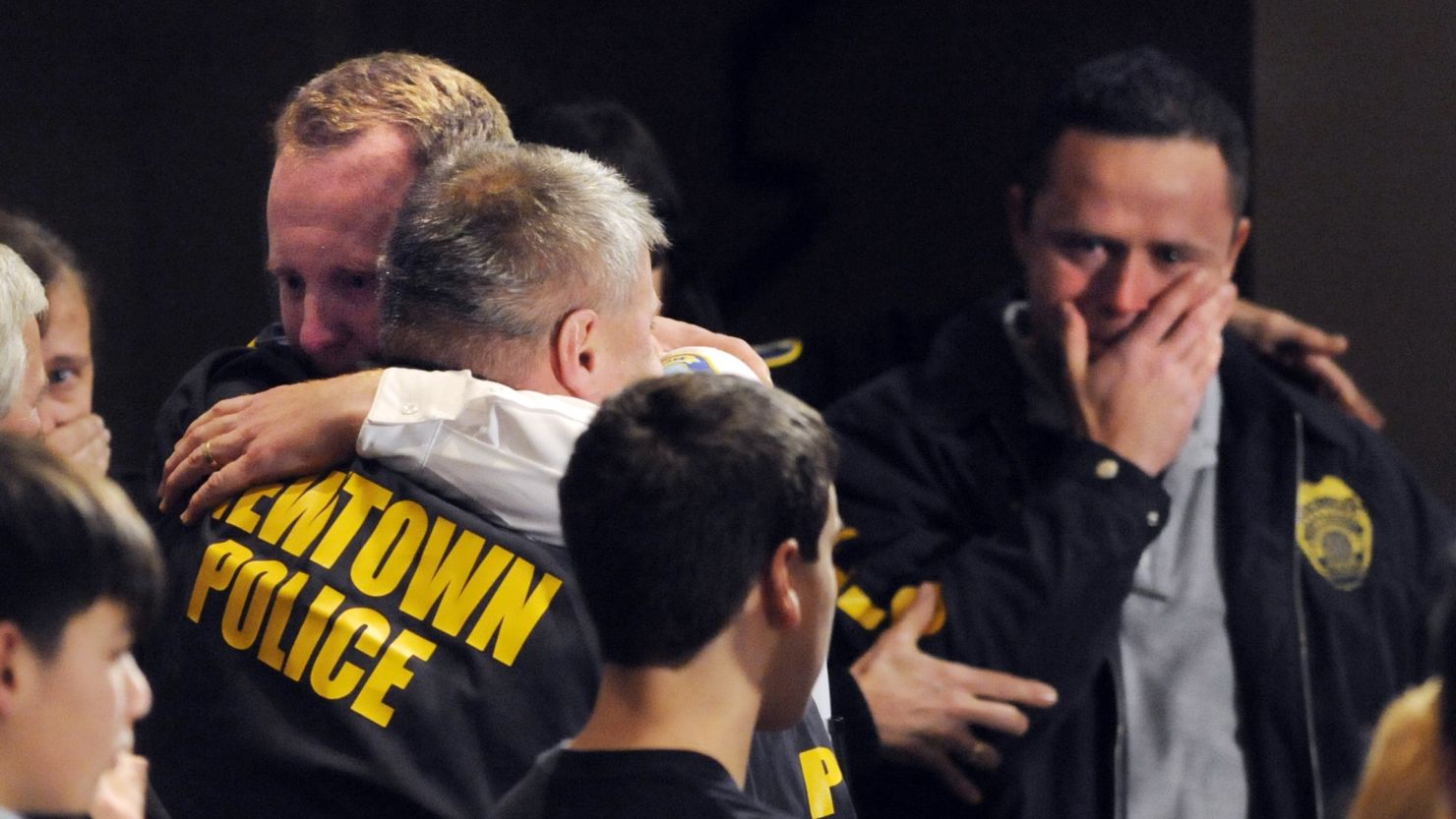 Newtown, Connecticut, first responders received an emotional standing ovation at a vigil for the school shooting victims on December 16.
