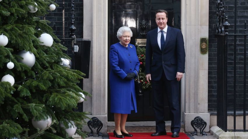 British Prime Minister David Cameron (R) greets Her Majesty Queen Elizabeth II as she arrives at Number 10 Downing Street to attend the Government's weekly Cabinet meeting on December 18, 2012 in London, England.