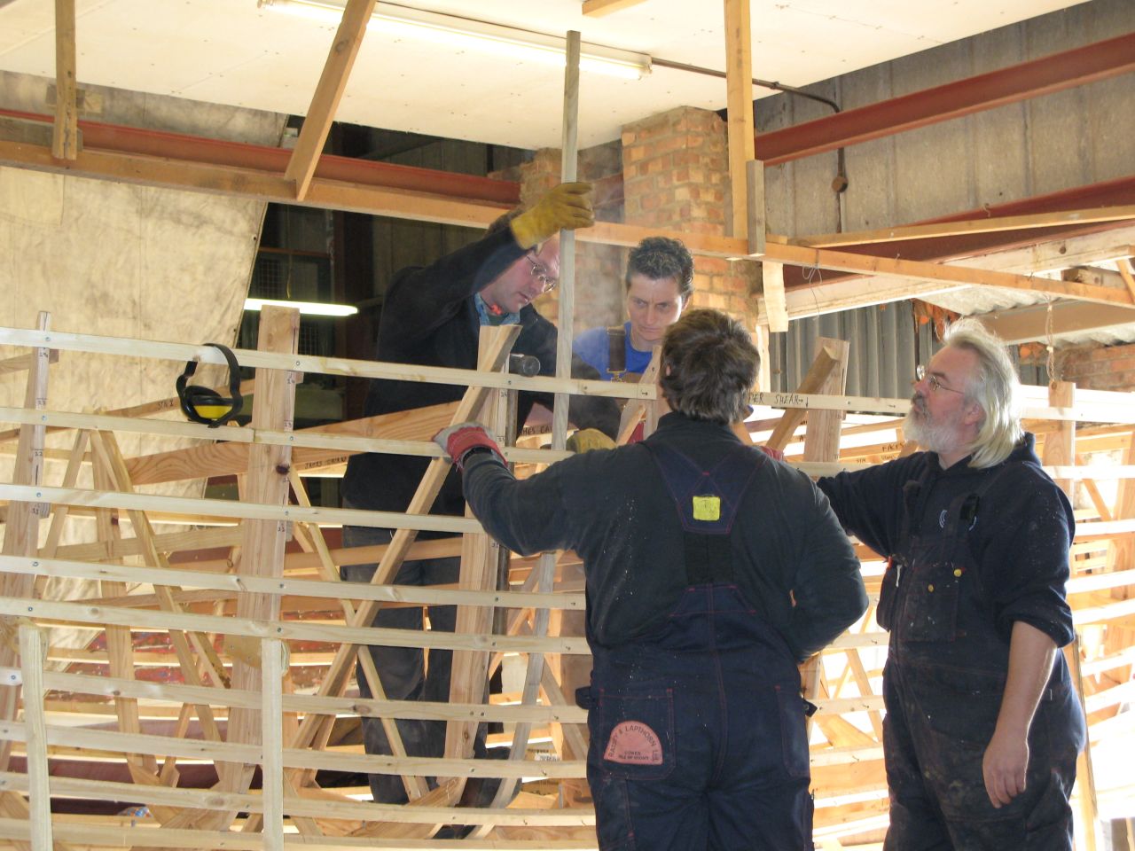 The crew are sailing in an exact replica of the original boat. Here boat-builder Nat Wilson (right) is seen  orchestrating the early stages of construction, which took two years to complete.