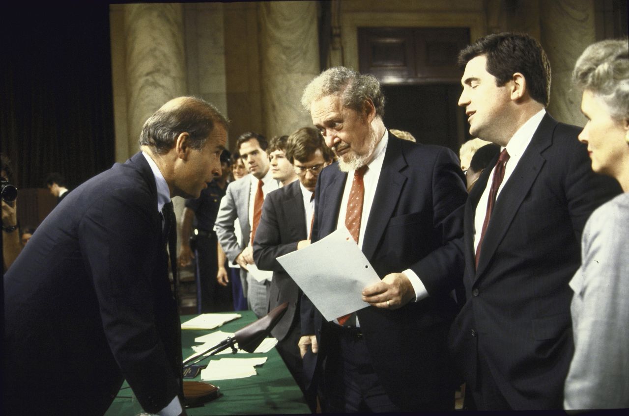 Joe Biden, left, then chairman of the Senate Judiciary Committee, chats with Bork and others after the first day of confirmation hearings.