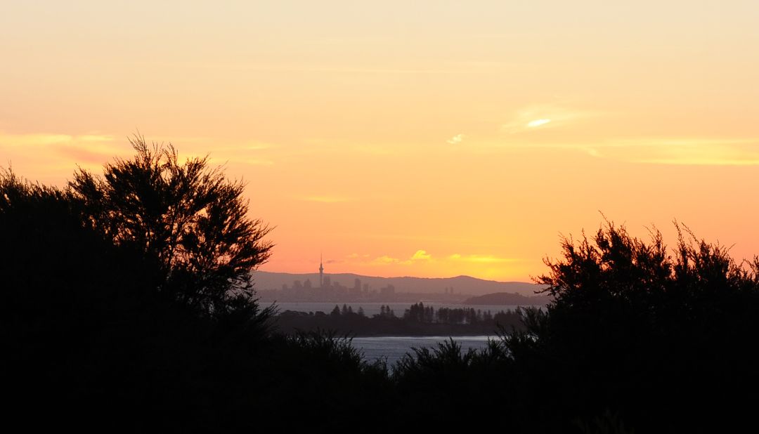 March is the perfect month to explore the New Zealand countryside. Here, Auckland is visible at sunset from Waiheke Island.