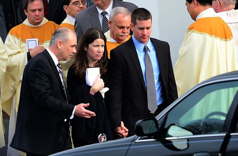 Richard and Krista Rekos leave after a funeral service for their 6-year-old daughter, Jessica, at Saint Rose of Lima Church on Tuesday, December 18, in Newtown. Jessica was one of 20 children killed in last week's school shooting.