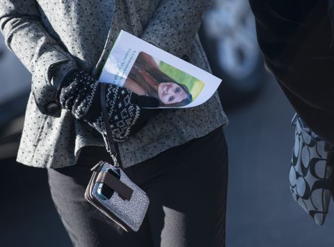 A woman carries a program with Soto's photo after attending a funeral for the slain teacher in Stratford on December 19.