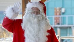 A man dressed in a Santa Claus costume poses with a sea lion at the animal exhibition park Marineland, on December 19, 2012 in Antibes, southeastern France.  AFP PHOTO / VALERY HACHE        (Photo credit should read VALERY HACHE/AFP/Getty Images)