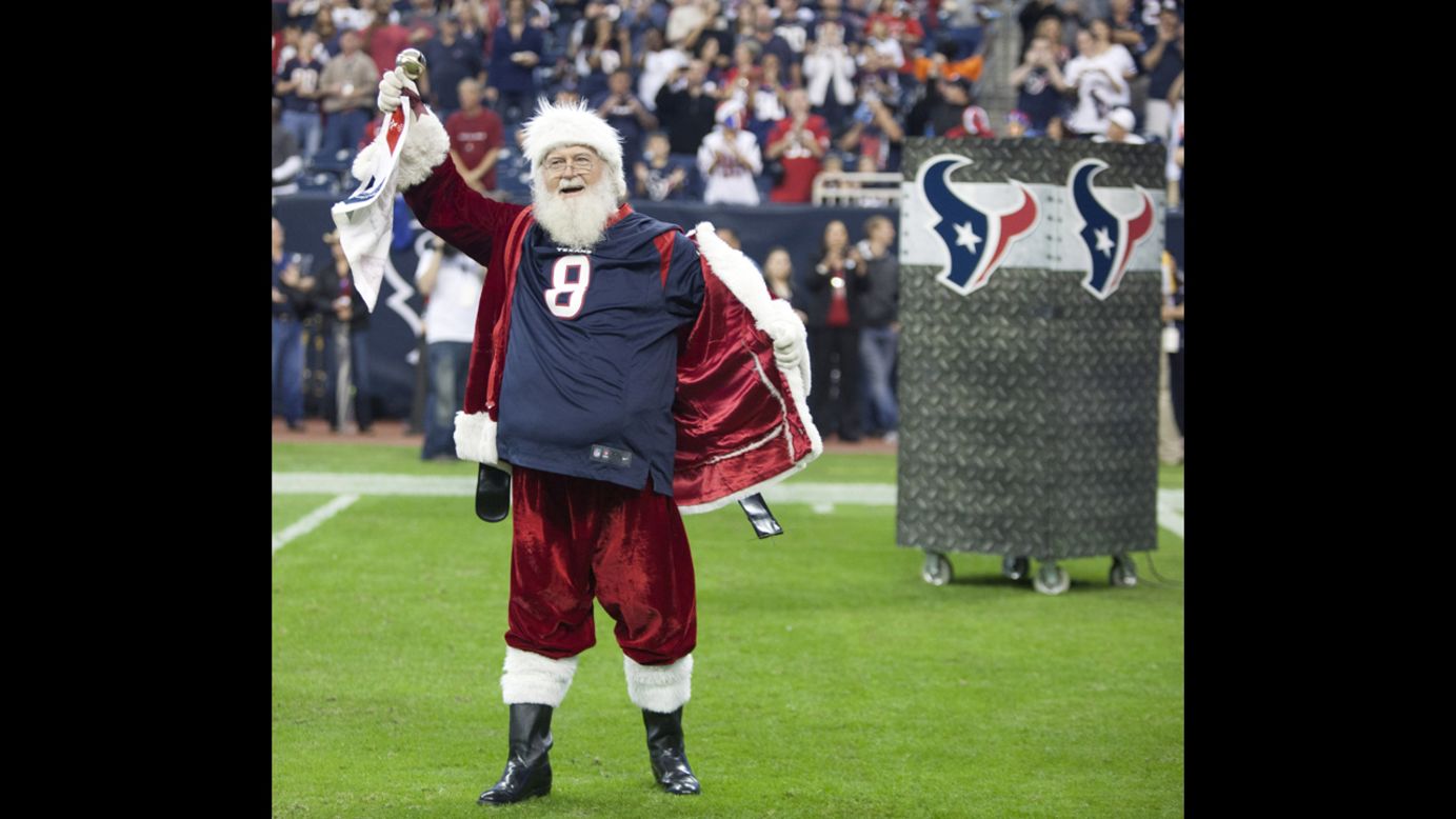 Santa Claus opens his coat to reveal a Matt Schaub jersey at Reliant Stadium on Sunday, December 16, in Houston, Texas, before the Texas Longhorns played the Indianapolis Colts. 