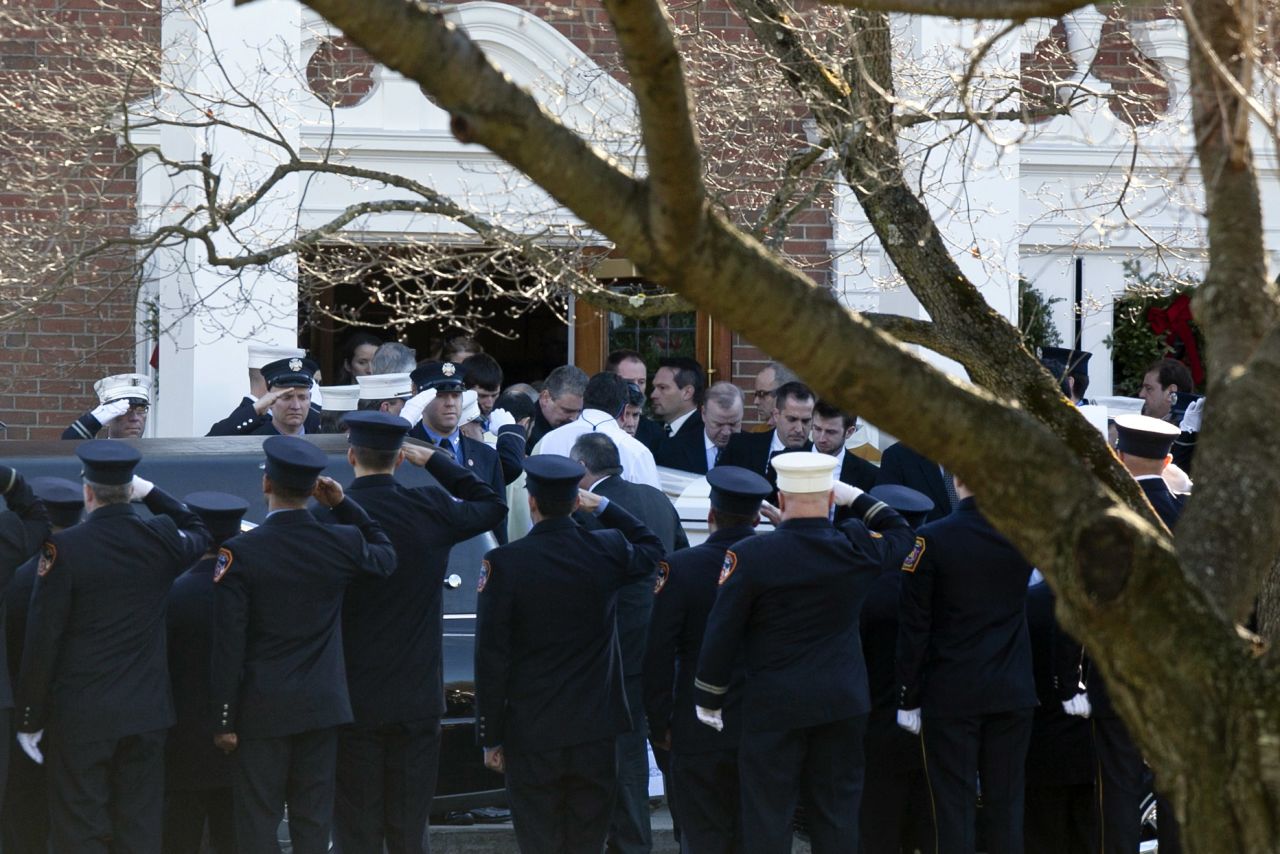 Firefighters salute as the casket of Daniel Barden, 7, a victim of the shooting at Sandy Hook Elementary School, is removed from St. Rose of Lima Church on Wednesday, December 19, 2012, in Newtown, Connecticut.
