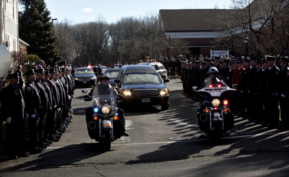 Police escort the hearse bearing the casket of Daniel Barden from St. Rose of Lima Church on December 19.