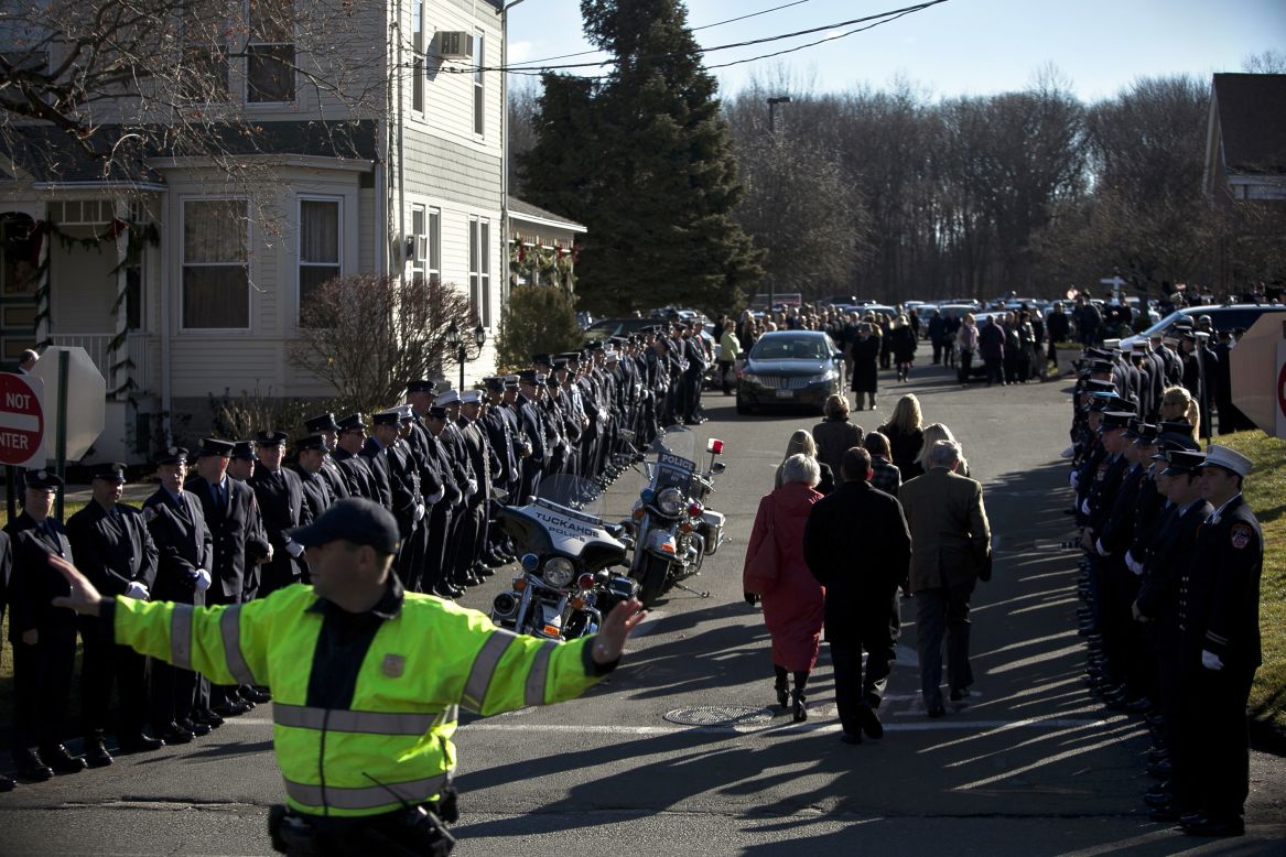 A police officer directs traffic as mourners enter the church for Charlotte Bacon's funeral on December 19.