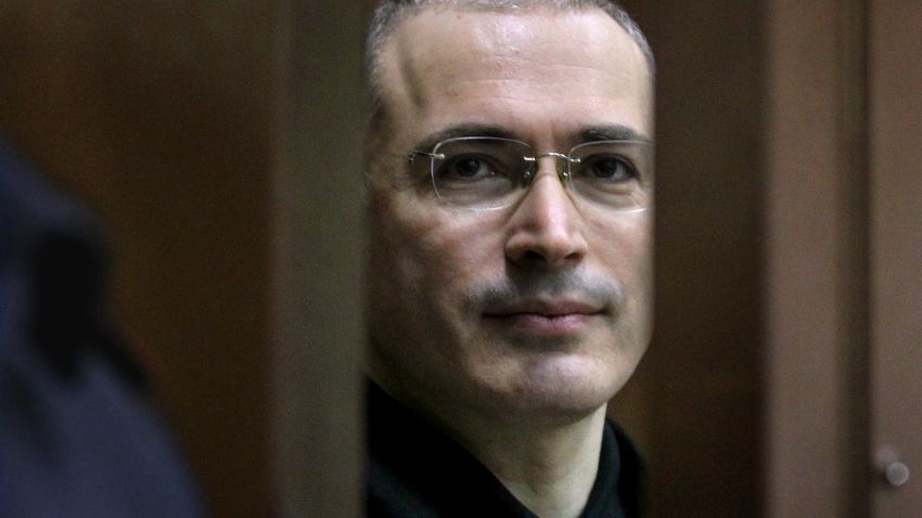 Former Yukos oil company CEO Mikhail Khodorkovsky looks on while standing behind the defendant glass cage in a courtroom, in Moscow, on November 1, 2010.