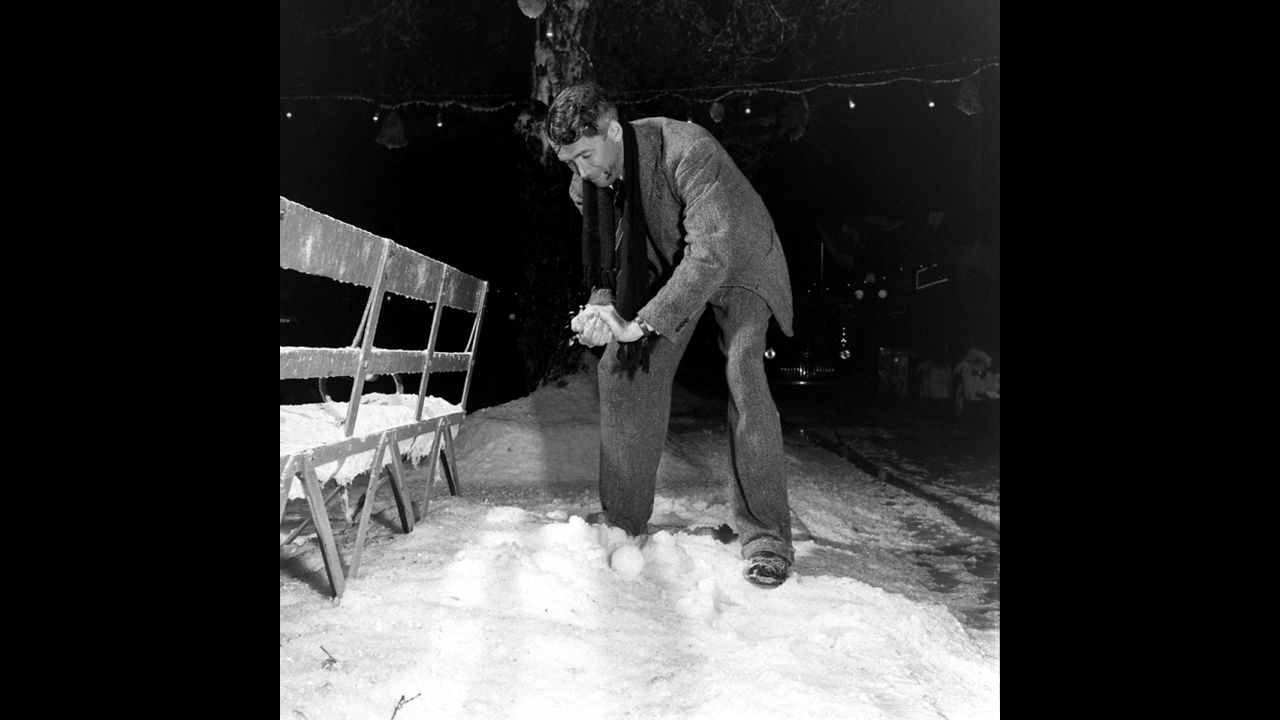 Actor Jimmy Stewart packs a snowball on the set of "It's a Wonderful Life." In the 1946 holiday classic, an angel shows frustrated businessman George Bailey what his community would have been like without him.
