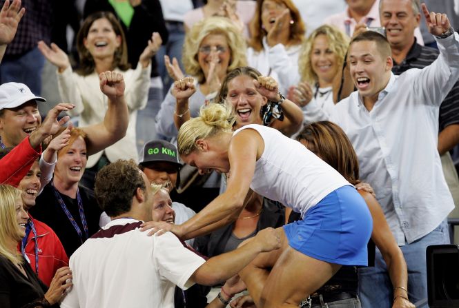 Clijsters had a love affair with New York. Here she climbs into the family area after the 2005 U.S. Open final after beating France's Mary Pierce 6-3 6-1 to clinch her first grand slam title.