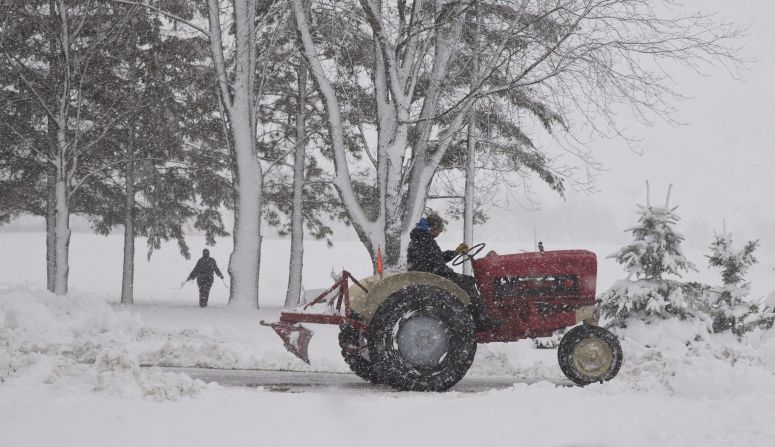 A man uses a tractor to clear snow in Waupun, Wisconsin, on December 20. 