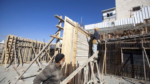 Palestinian laborers work on a construction site in the east Jerusalem settlement of Ramat Shlomo, on December 18, 2012. 
